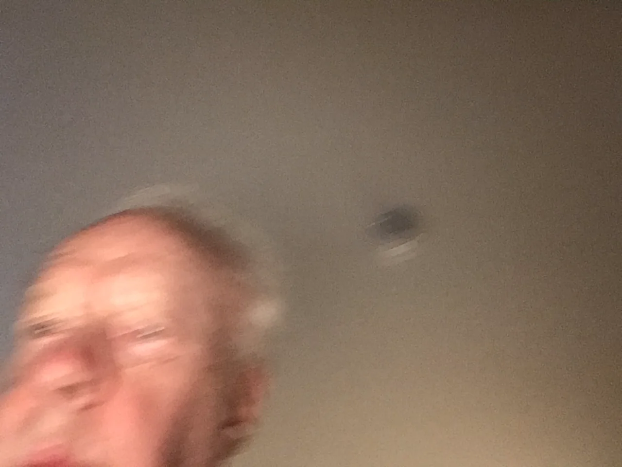 A photograph of an old white man wearing a suit and tie.