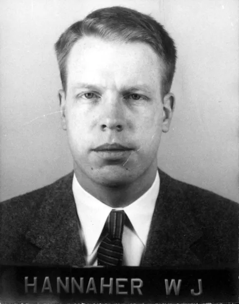 A scan of a photograph of a trim white man in a jacket and tie.
