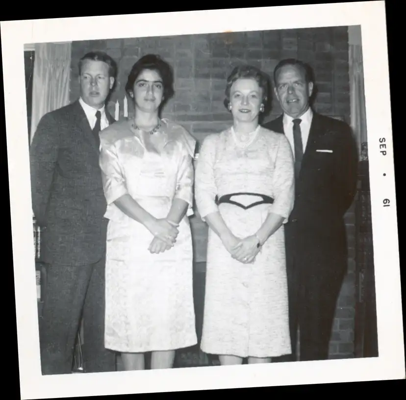 A photograph of two couples standing in front of the fireplace in Moorhead.