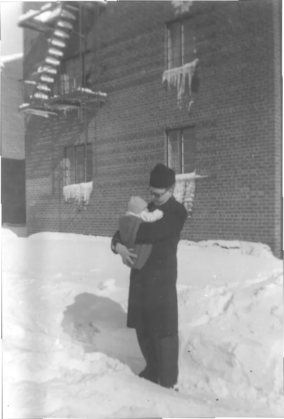 William Hannaher carries his son, Queens has had a snowfall.