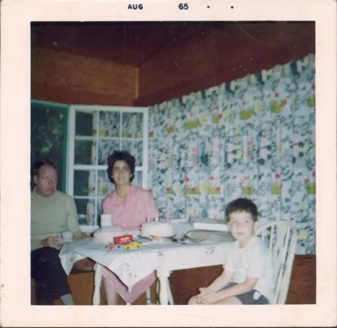 A photograph of the family inside a lake cottage.